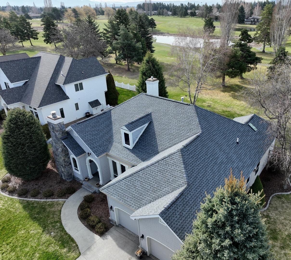 side aerial view of pristine shingle roof replacement