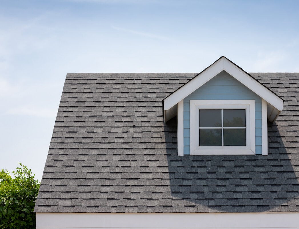 close up of asphalt shingles on rooftop with gable