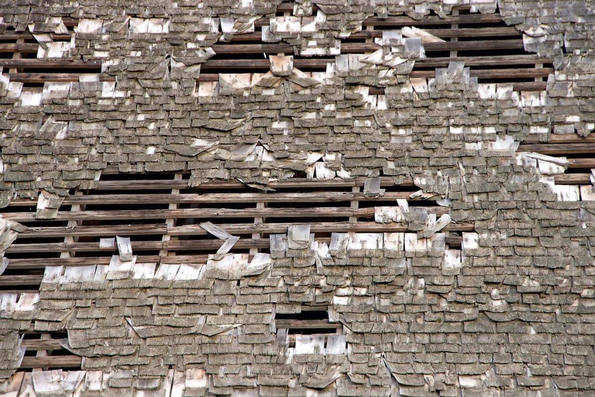Wood shake shingles roof that was damaged by wind and rain, needs to be replaced.