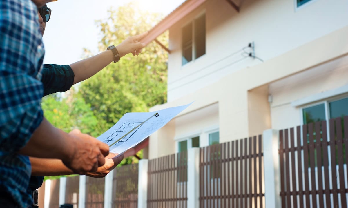 Roof inspector holding a paper plan/blueprints