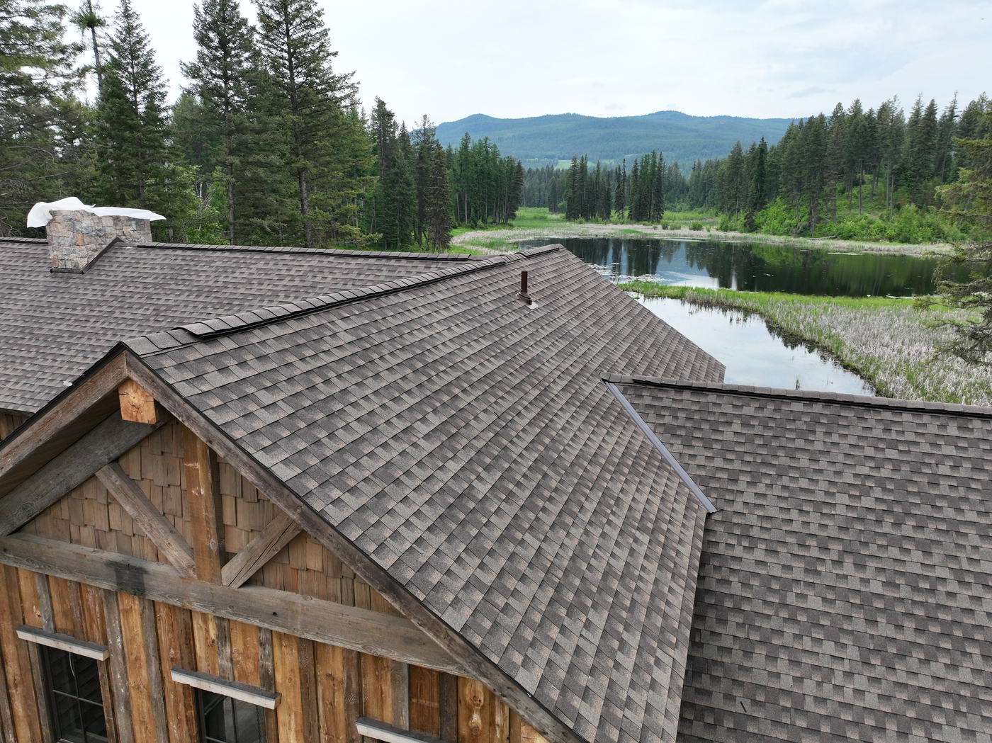 ridge view of sleek new roof installed on lakeside residential home