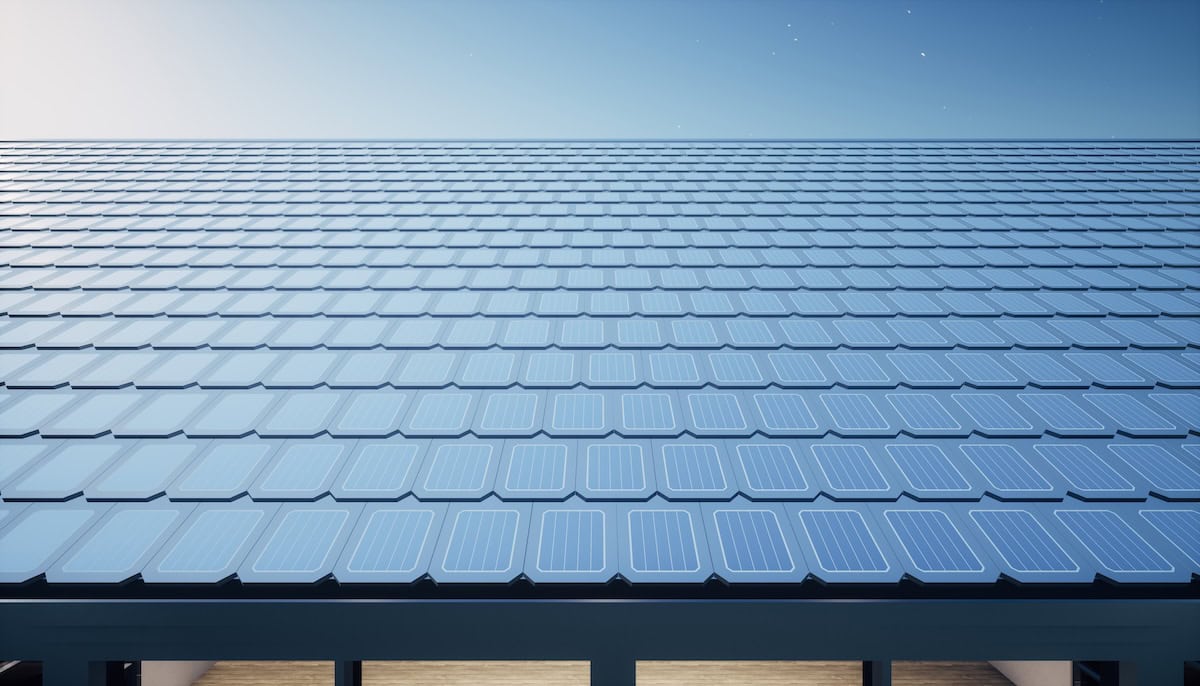 solar or photovoltaic shingles in perspective on roof of home or house building.