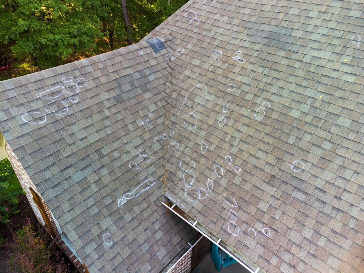 storm damage roof inspection hail impact holes marks 