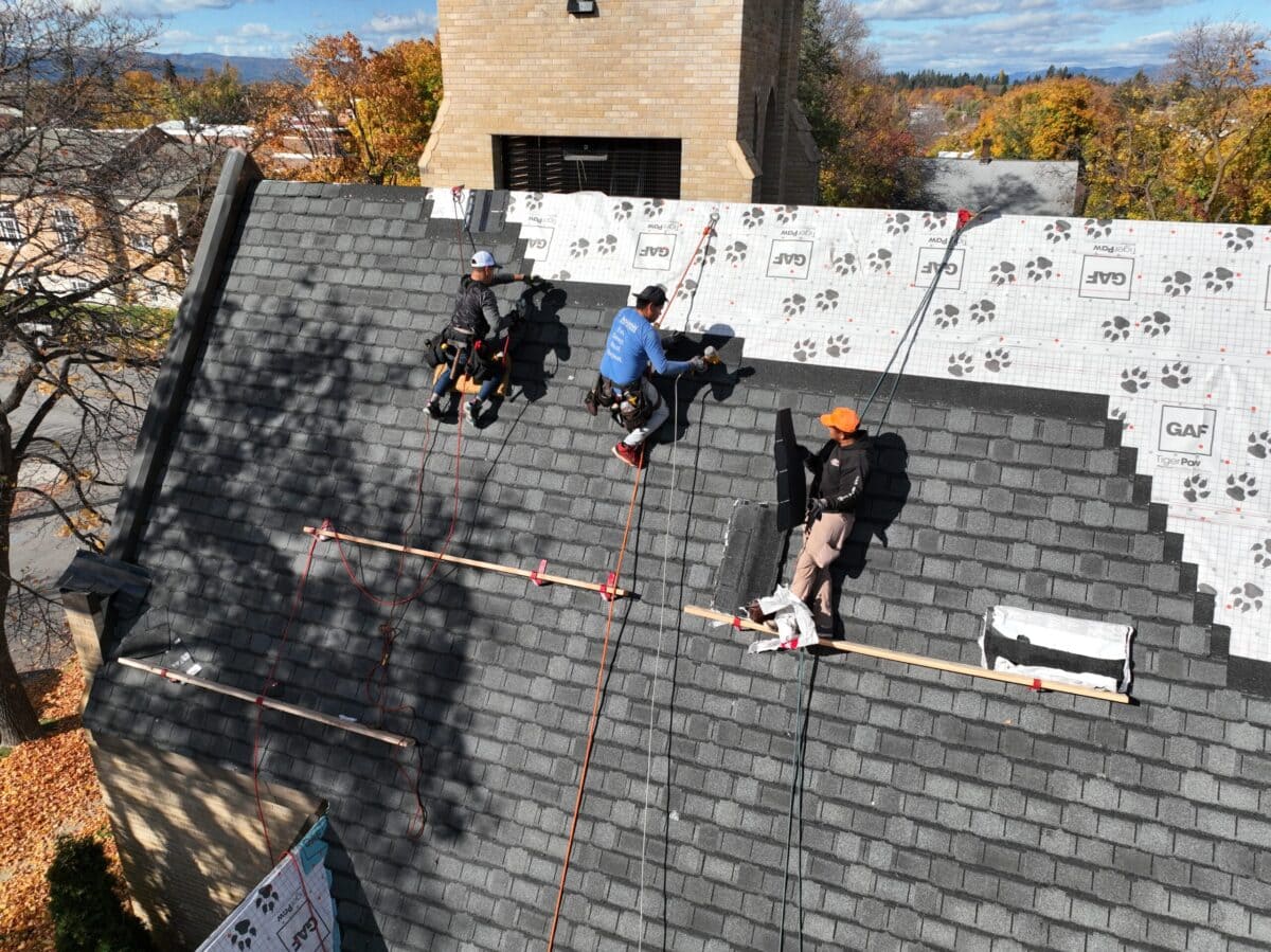 roof wind damage Montana Roofing workers replacing shingles 